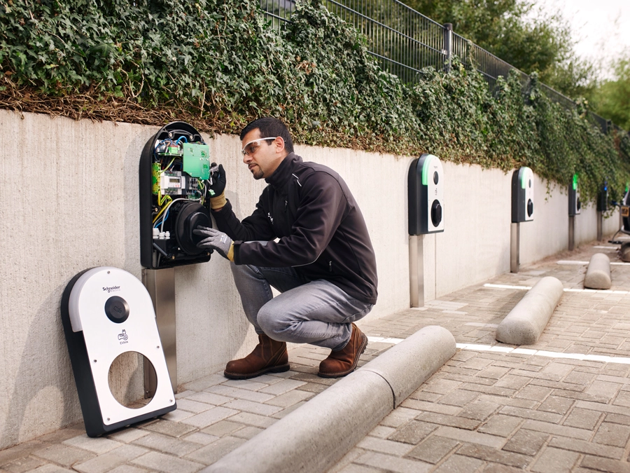 Man fixing EV charger