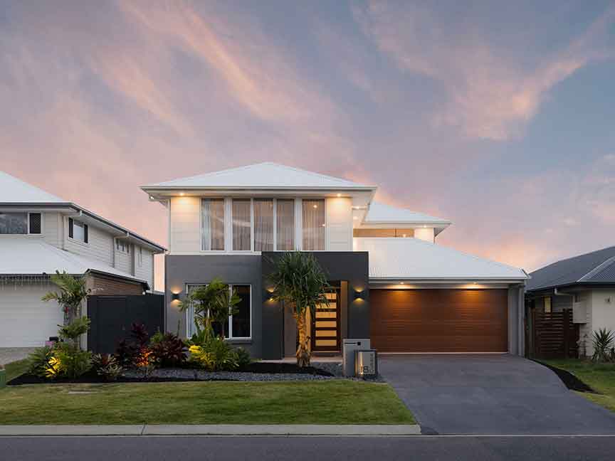 A minimalist, contemporary house with a warm, inviting ambiance created by strategic lighting design