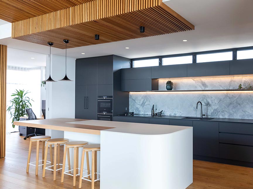 Kitchen with a bar and stools.