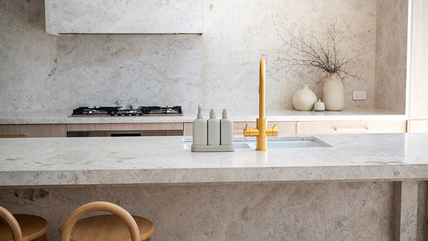 A clean kitchen with a sink and a counter.