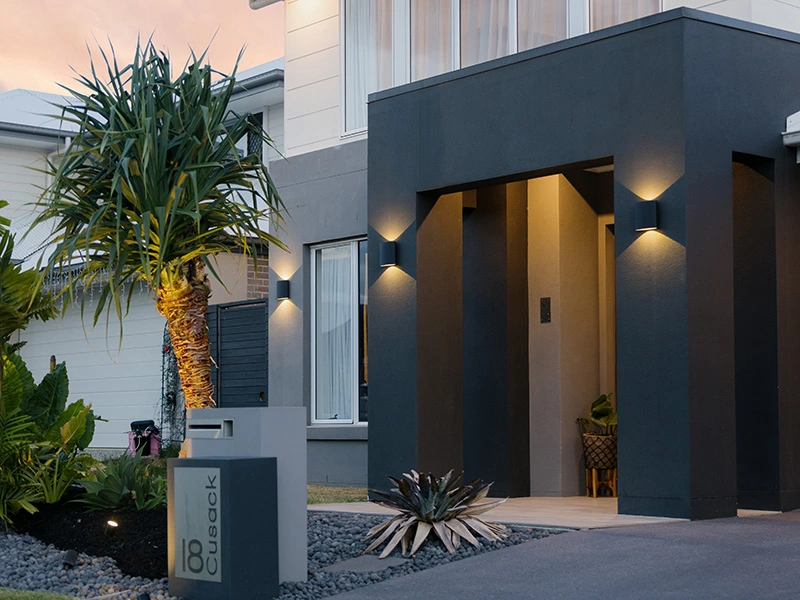 Contemporary house featuring a spacious front porch and a stylish mailbox at the entrance