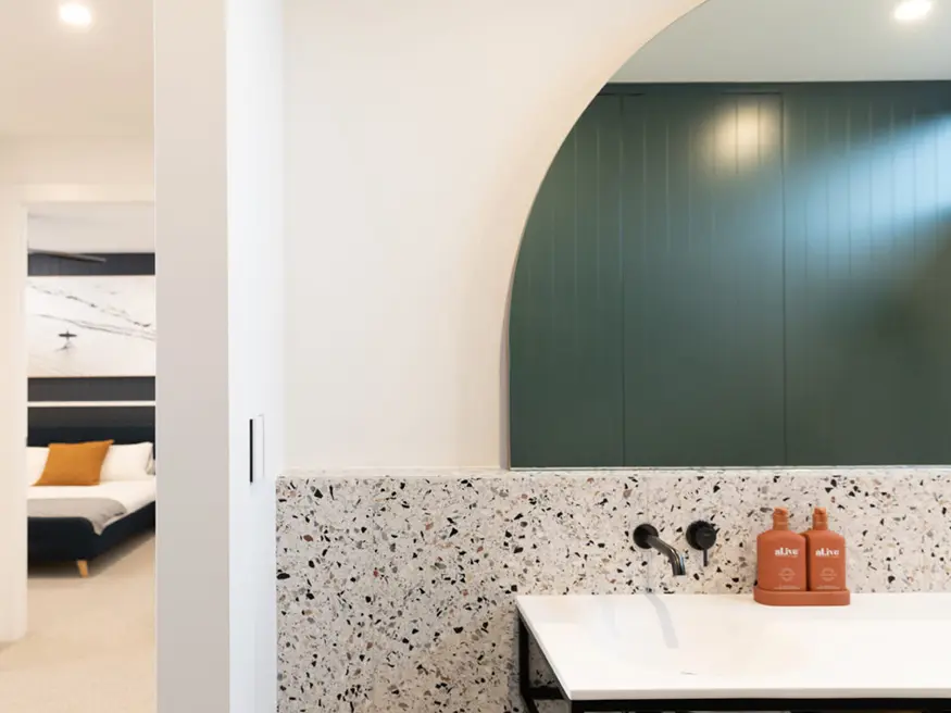 Bathroom with white pedestal sink and chrome faucet.