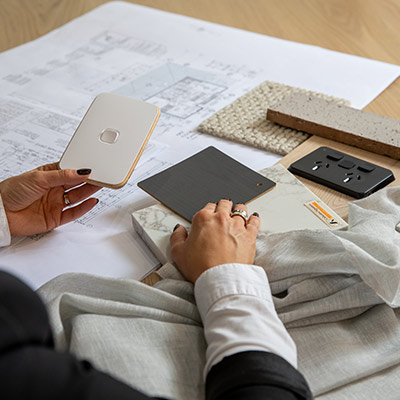 Woman's left hand holding an Iconic Essence arctic white switch 