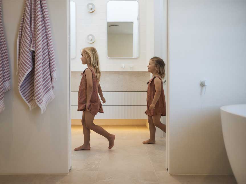 two children exploring bathroom