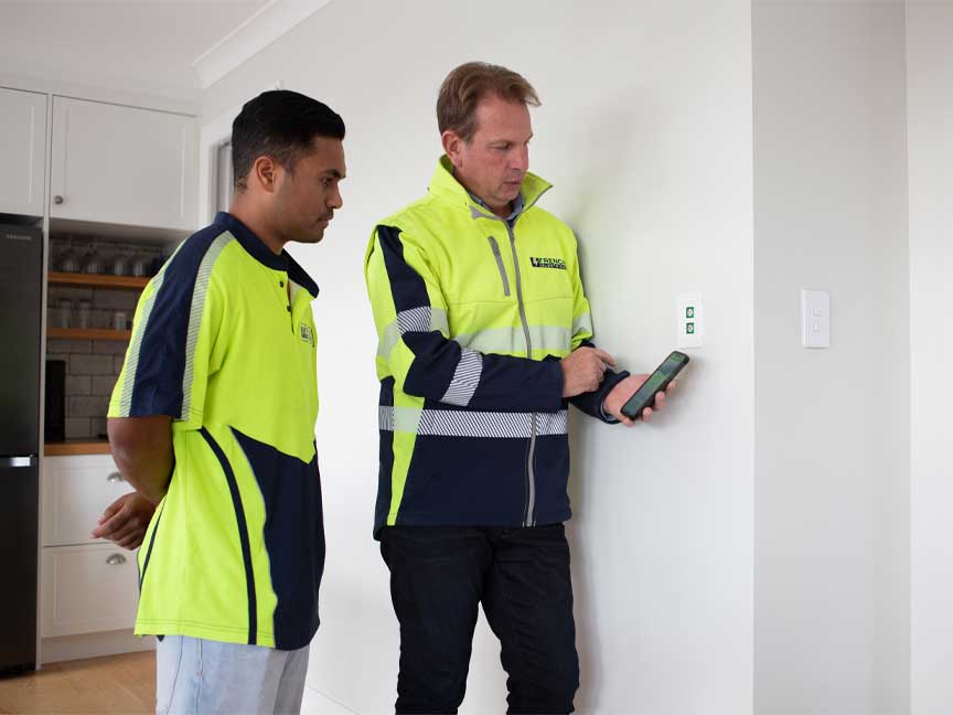 Electrician showing Wiser smart home functions to college 