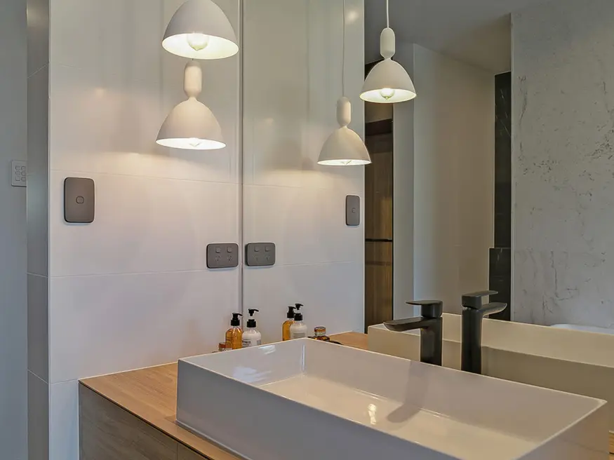 Bathroom with chrome faucet and single sink.