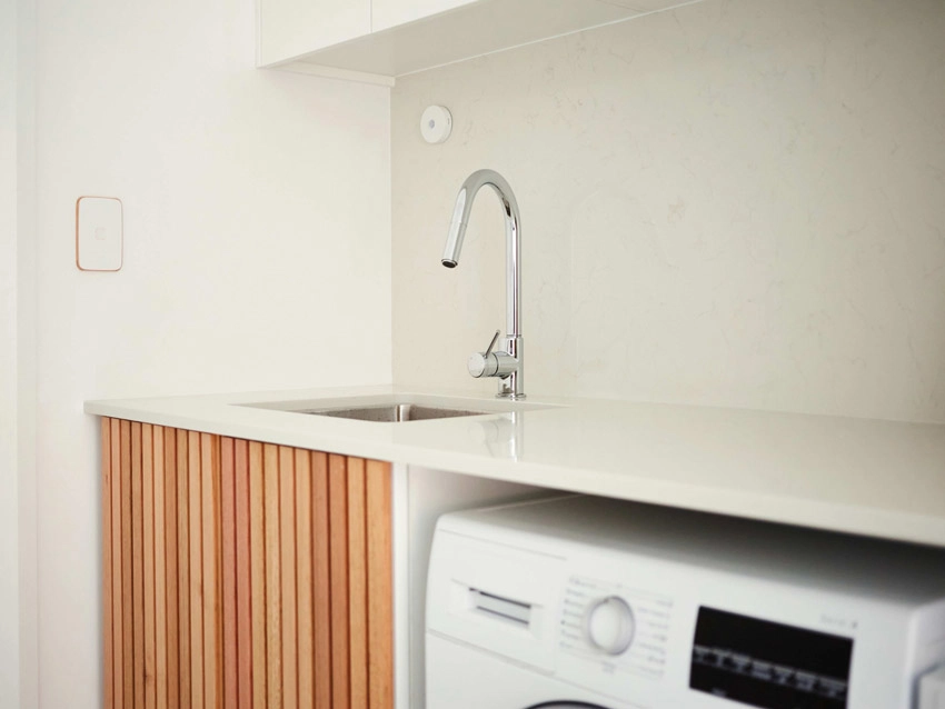 Kitchen with a sink and a washer and dryer