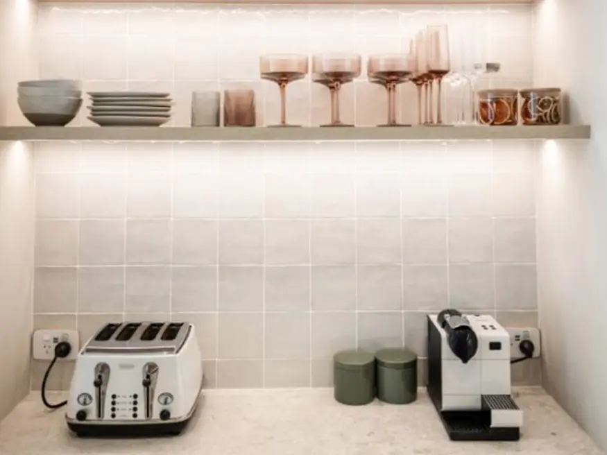 Kitchen counter with toaster and coffee maker.