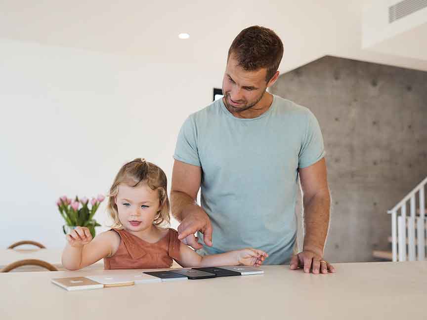 The father guides his daughter's hand as they meticulously choose from an array of seven unique switch options