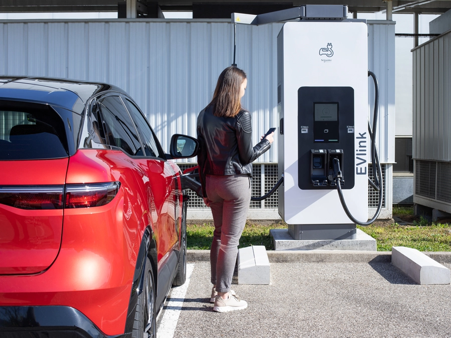 Woman charging car using EV link