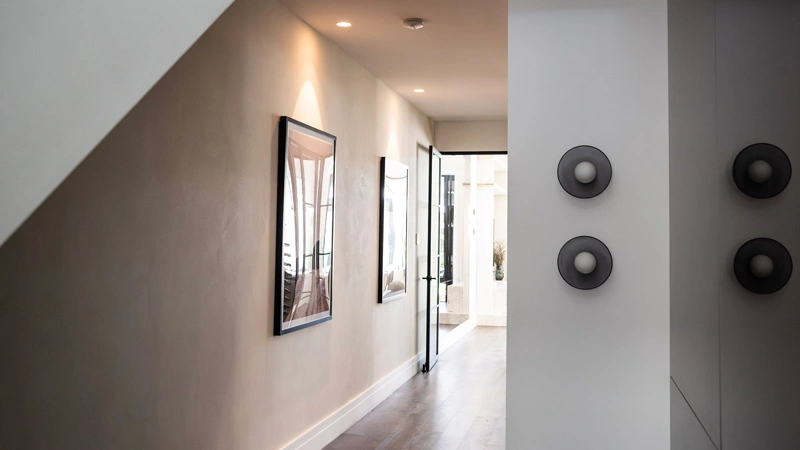 Hallway illuminated by two circular lights on the wall