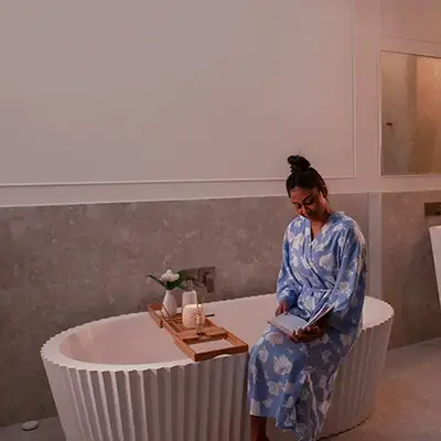 Woman sitting on bathtub