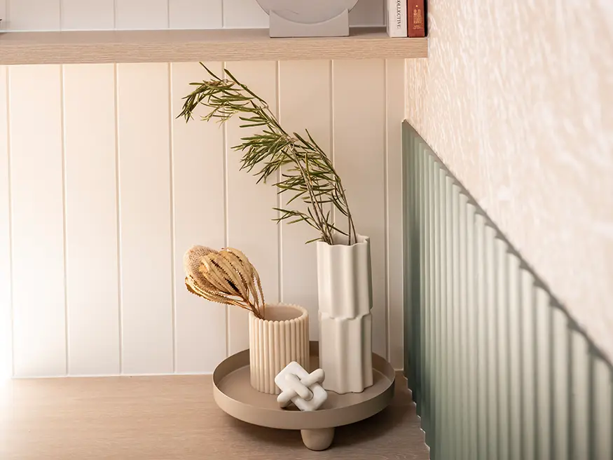 Wicker basket under desk for storage.