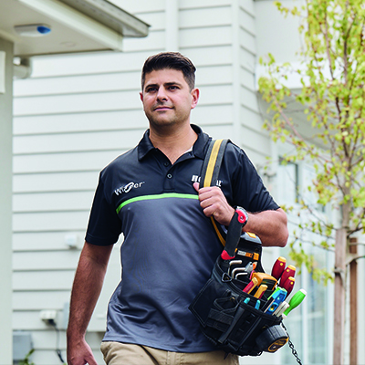 A Clipsal Wiser Approved Installer carrying tools to their next Smart Home Wiser installation