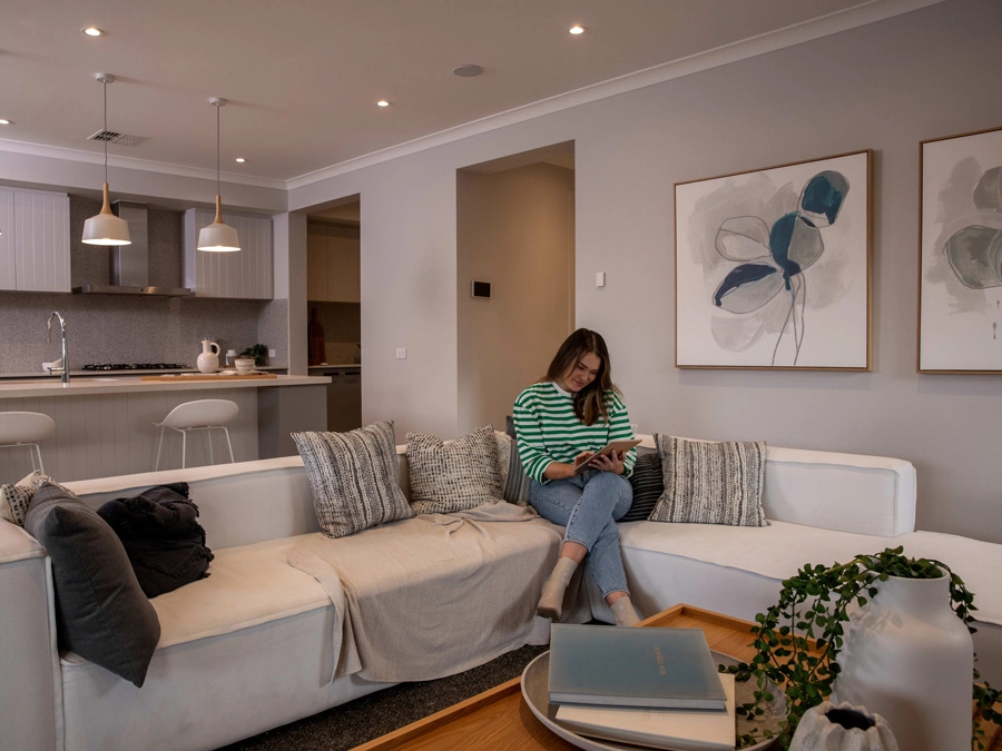 Woman reading a book in her living room