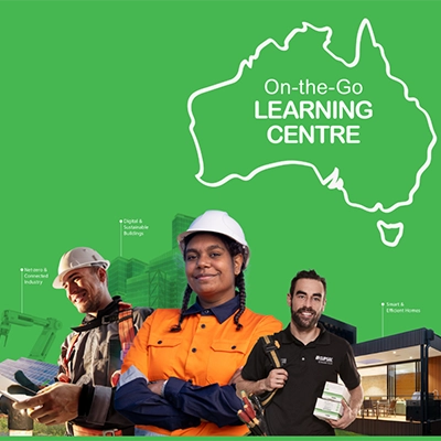 An electrician, panel builder and contractor smiling, standing below a map of Australia with the words 'On-the-Go Learning Centre' 