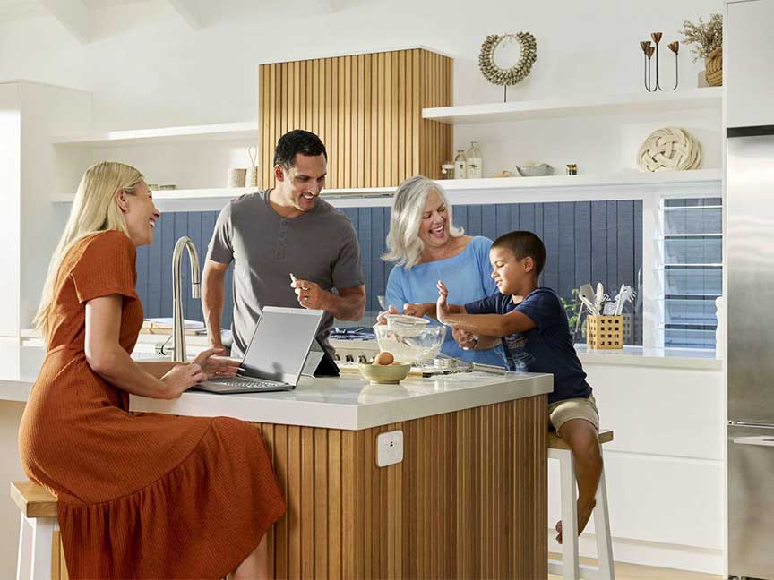 A family gathered around a kitchen island.