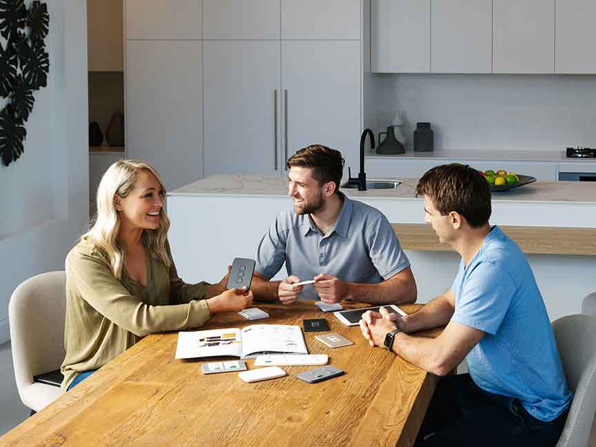 A group of people discussing Clipsal switch options for electrical projects