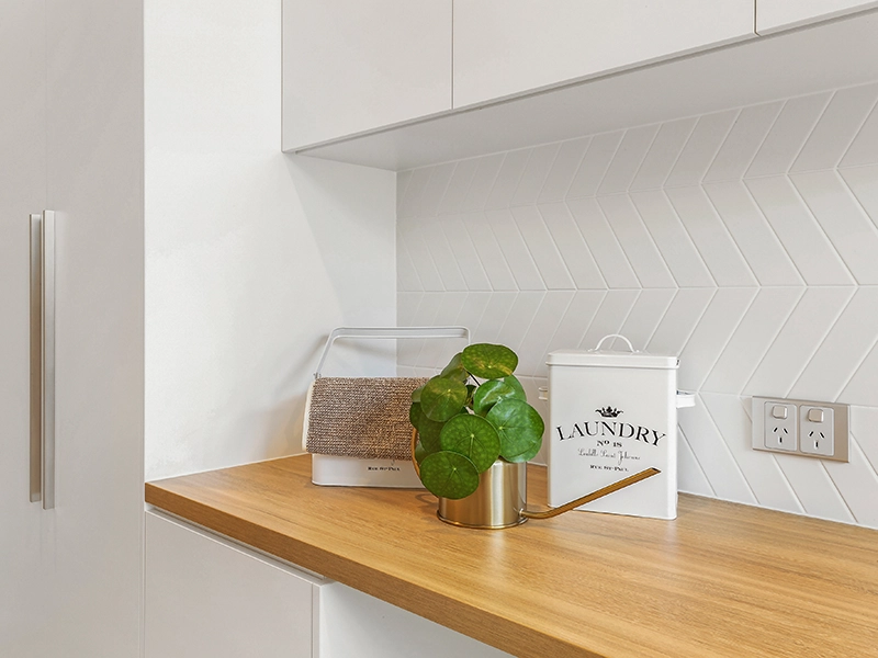 Modern laundry room with a wooden countertop