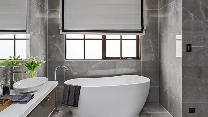 Bathroom with bathtub, sink, and window